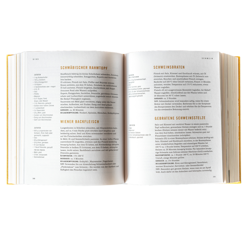 A white plate with a bread roll and three spoonfuls of flavored butter or spread, garnished with herbs.